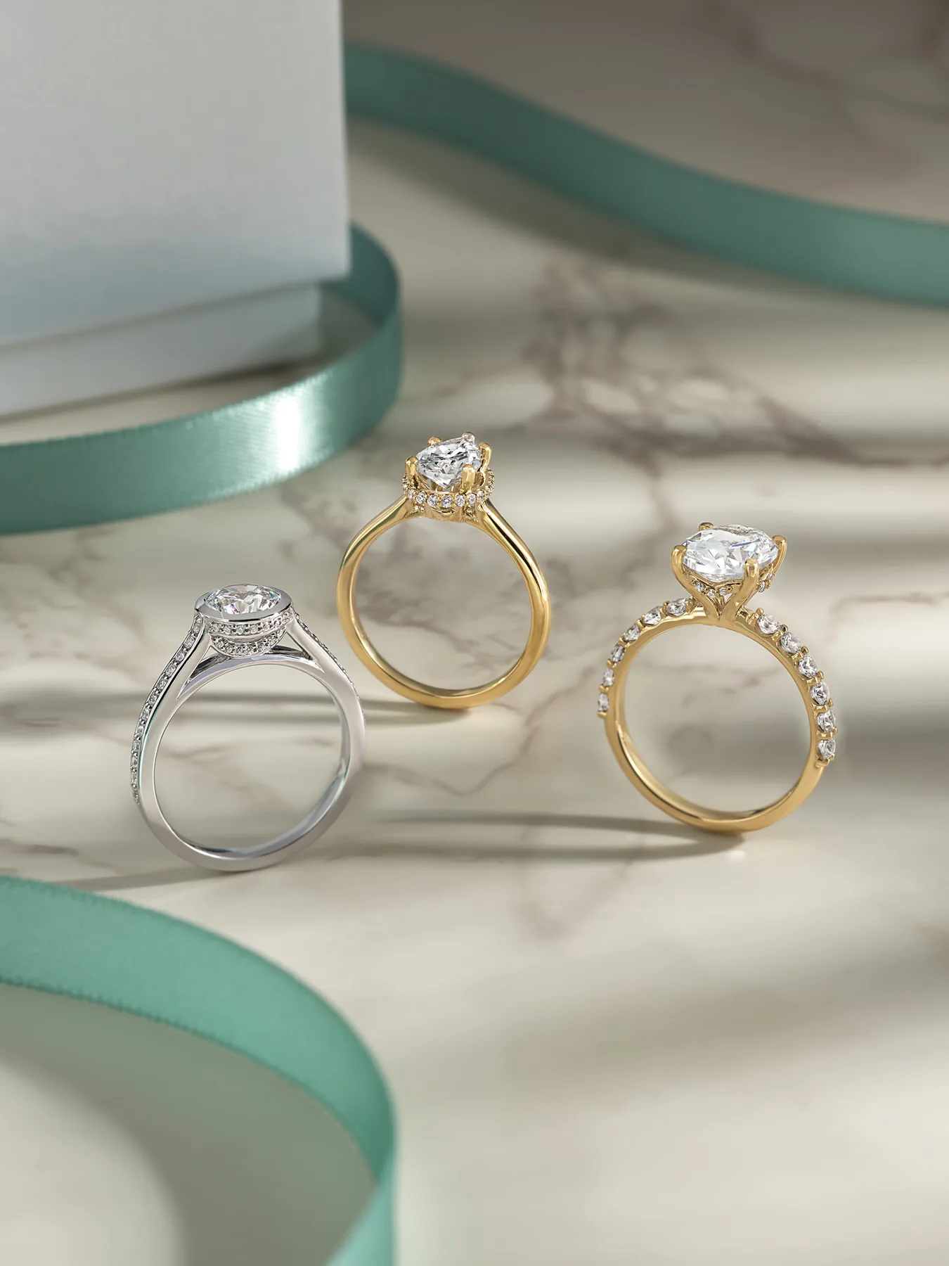Pear and oval diamond engagement ring designs in white and yellow gold