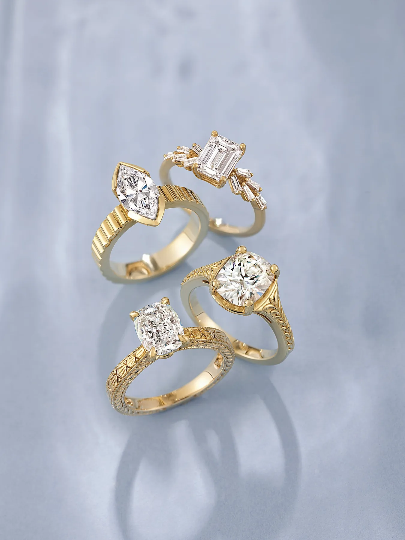Yellow gold engagement ring designs with marquise, emerald, cushion and oval diamond shapes